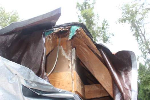 Snapped rafter ends under a tarp